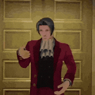 a man in a red suit is standing in front of a door in a room .