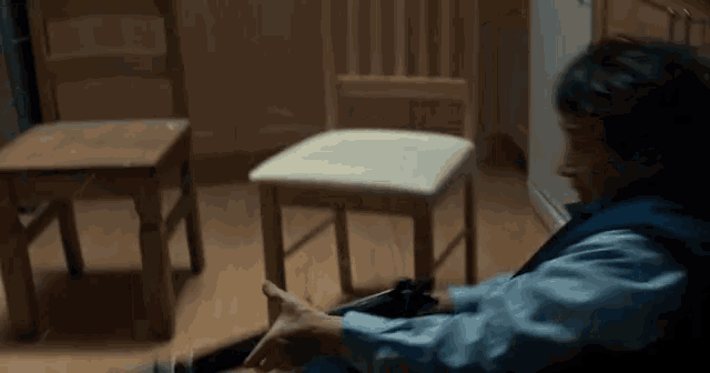 a man is sitting on the floor in front of a chair