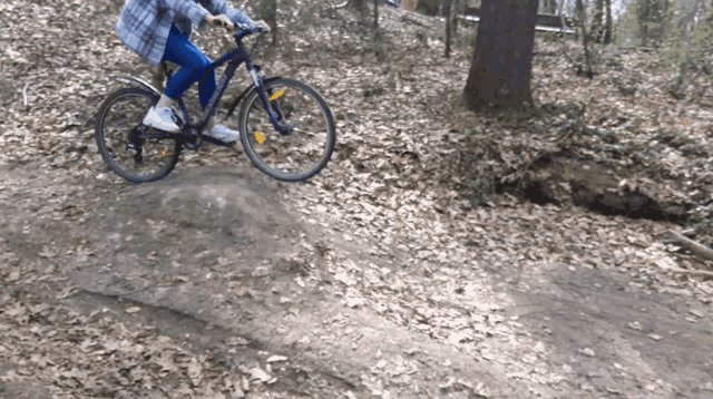 a person is riding a bike on a dirt path