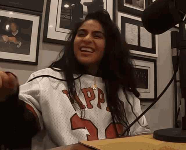 a woman wearing a jersey that says kappa on it