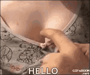 a person is touching a woman 's breast with their finger and saying `` hello '' .