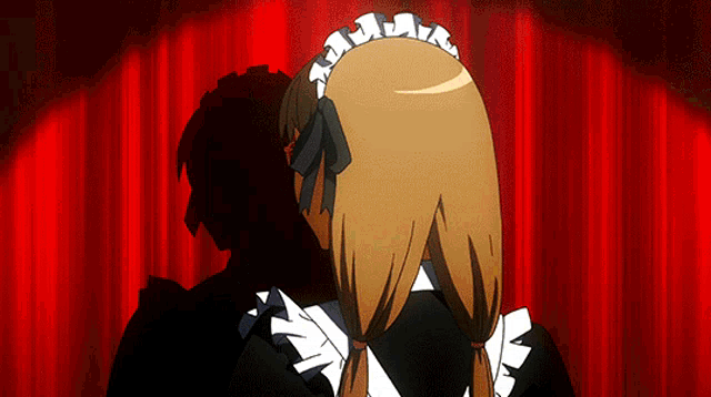 a maid stands in front of a red curtain