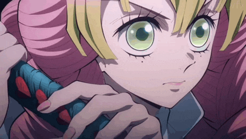 a close up of a girl 's face with pink hair and green eyes