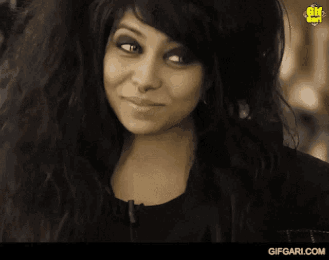 a woman with long hair is smiling and says wow wow