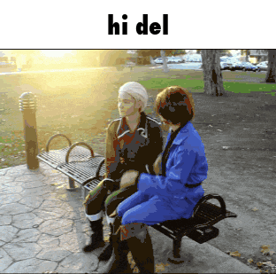 a couple of people sitting on a bench with the word hi del above them