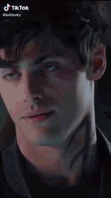 a close up of a man 's face with a tiktok logo on the bottom