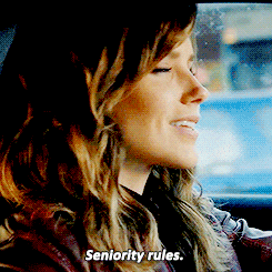 a woman in a car says " seniority rules " at the bottom of her face