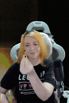 a woman with orange hair is wearing a shirt that says le