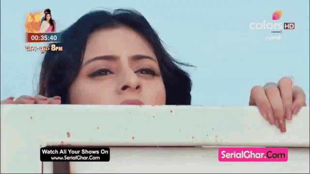 a tv screen shows a woman and says watch all your shows on serialghar.com