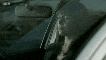 a woman sits in a car with bbc written on the bottom right