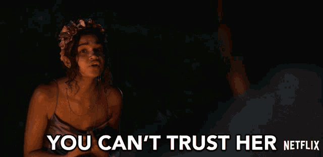 a woman with a flower crown on her head says " you can 't trust her netflix "