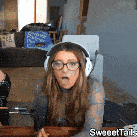 a woman wearing headphones and glasses is sitting in front of a microphone with sweettails written on the bottom right