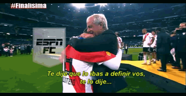 a man hugging another man on a soccer field that says espn fc on the bottom
