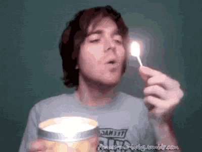 a man is lighting a candle with a match