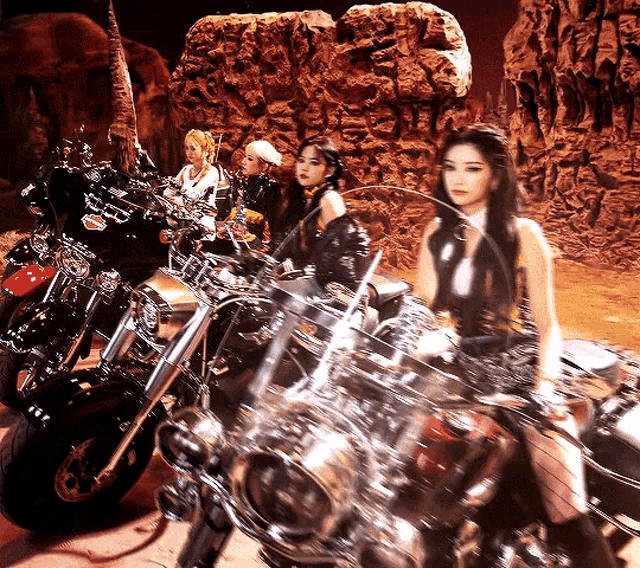 a group of women are riding motorcycles in a desert scene