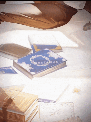 a stack of books on a table one of which says ' hatanas ' on the cover