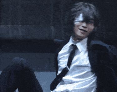 a man in a white shirt and black pants is laying on the floor