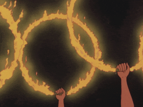 a hand is holding a ring of fire that looks like the letter y
