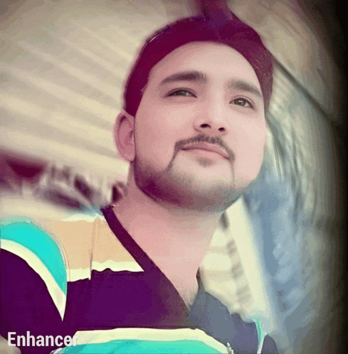 a close up of a man 's face with the word enhance on the bottom right