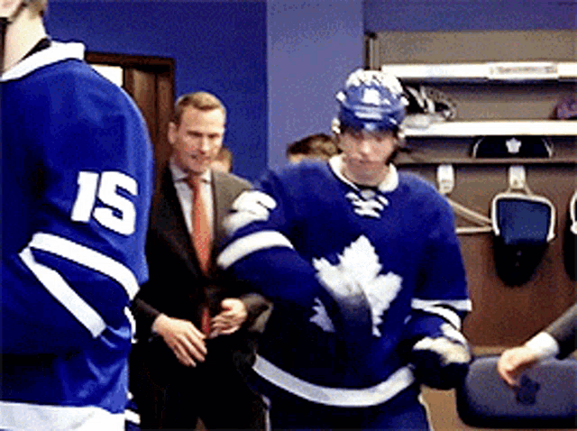 a hockey player wearing a jersey with the number 15 on it