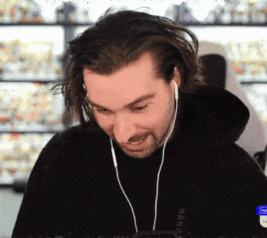 a man wearing ear buds and a black shirt that says nana
