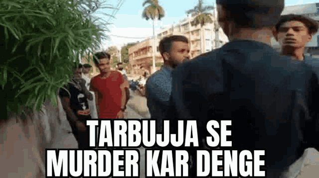 a group of men are standing next to each other on a sidewalk and talking to each other .