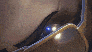 a close up of a person wearing sunglasses with a blue light coming out of it