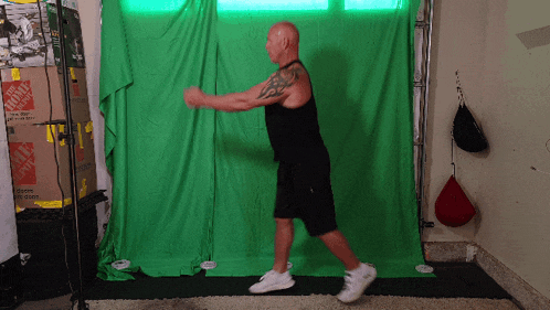 a man is standing in front of a green screen with the home depot boxes behind him