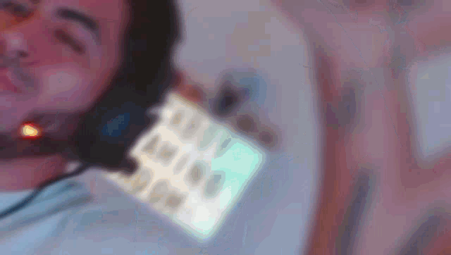 a blurry picture of a man wearing headphones and a badge that says ' daddy ' on it .