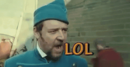 a man with a beard wearing a blue hat and a white shirt is screaming with the word lol behind him .