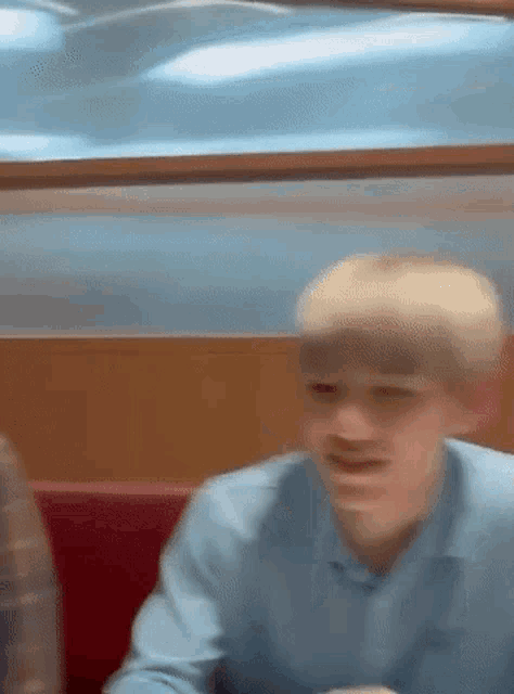 a blurry picture of a man sitting at a table in a diner