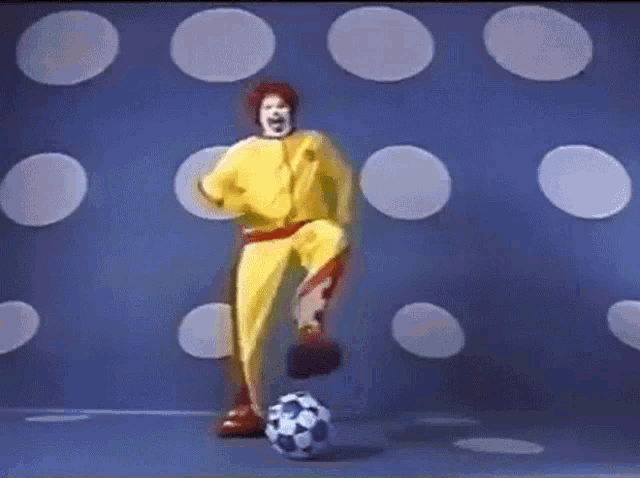 a mcdonald 's character kicks a soccer ball in front of polka dots