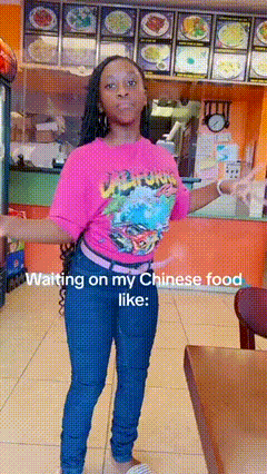 a woman in a pink shirt is waiting on chinese food