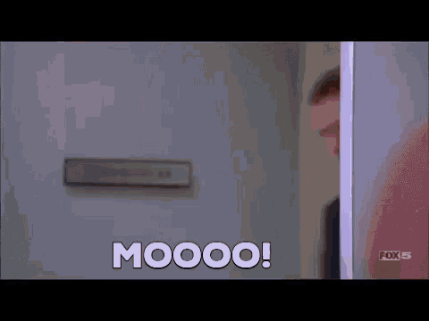 a blurry picture of a man standing in a doorway and saying moooo .