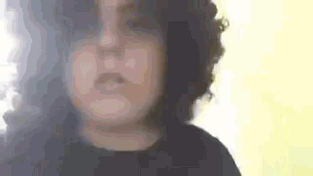 a close up of a person 's face with smoke coming out of it and a yellow background .