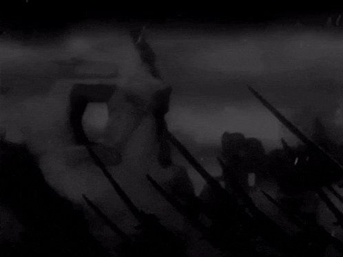 a black and white photo of a group of soldiers holding swords