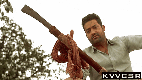 a man holding a sword with a kvvcsr logo on the bottom