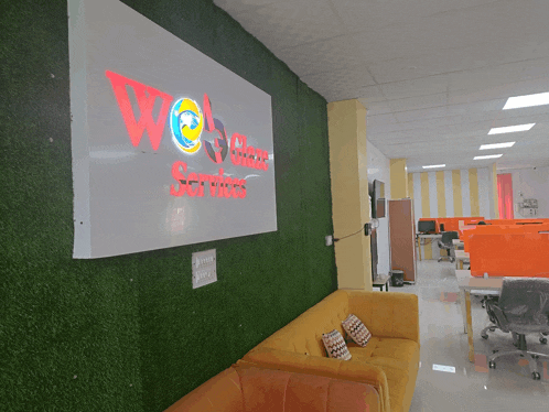 a yellow couch sits in front of a sign that reads web class services