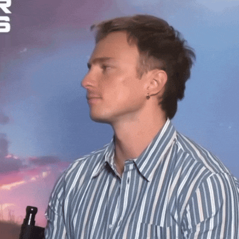 a man wearing a blue and white striped shirt looks to his left
