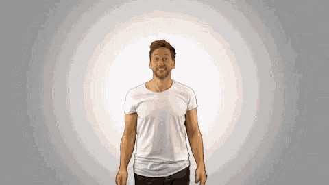 a man wearing a white t-shirt is making a face