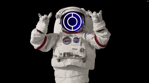 a man in an astronaut 's suit is making a rock and roll sign with his hands .