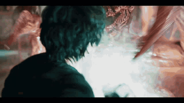 a person is standing in a dark room with a monster coming out of it