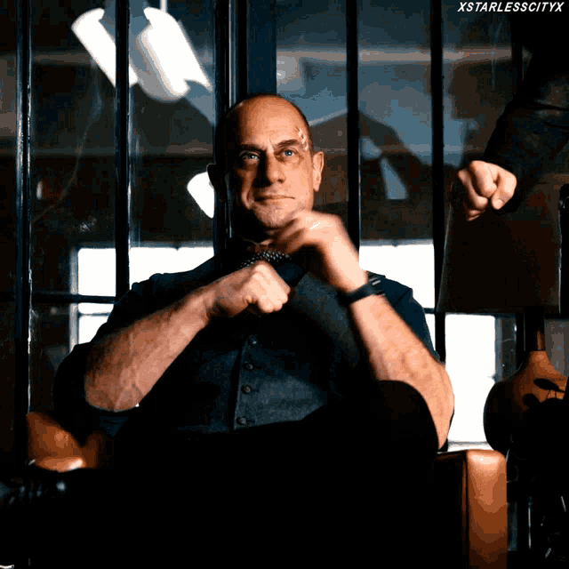 a man sitting in a chair with xstarlesscityx on the bottom right