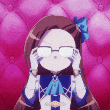 a girl wearing glasses and a blue bow on her head
