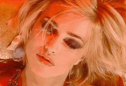 a close up of a woman 's face with makeup on her eyes