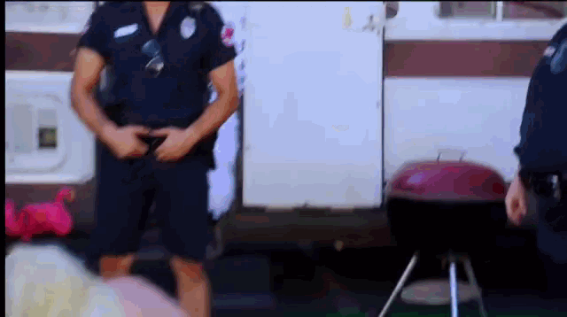 a police officer standing in front of a grill