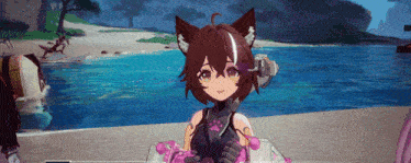 a girl with cat ears is standing on a beach next to a body of water .