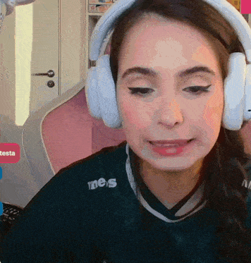 a woman wearing headphones and a shirt that says nes on it