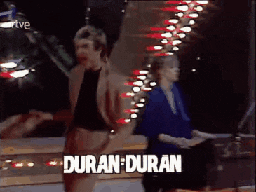 a man and a woman are dancing with the words duran duran written on the screen