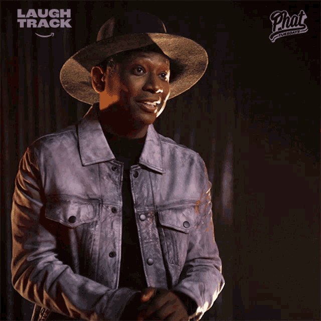 a man wearing a hat and a jacket with laugh track written on the bottom